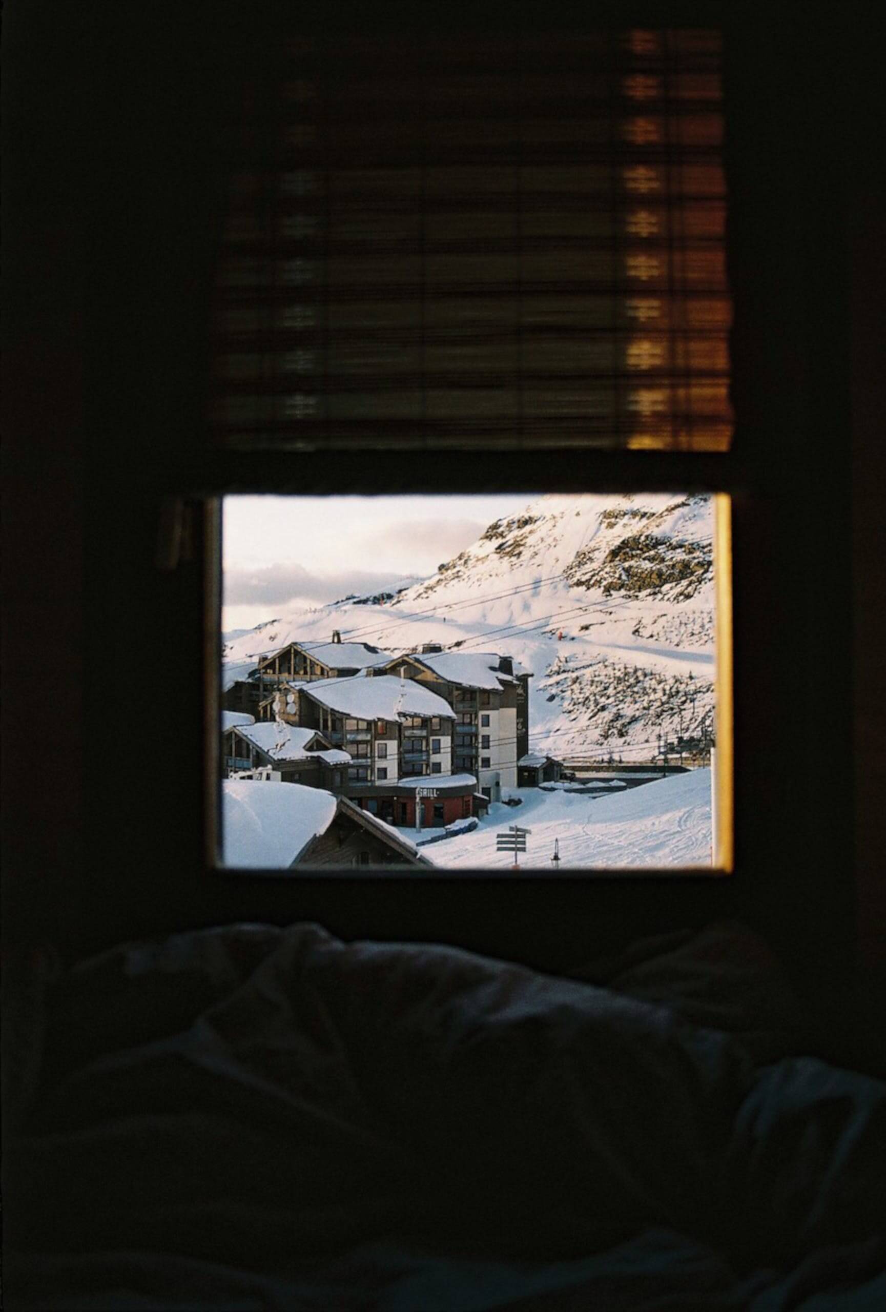 Image of a snowy hotel through a window
